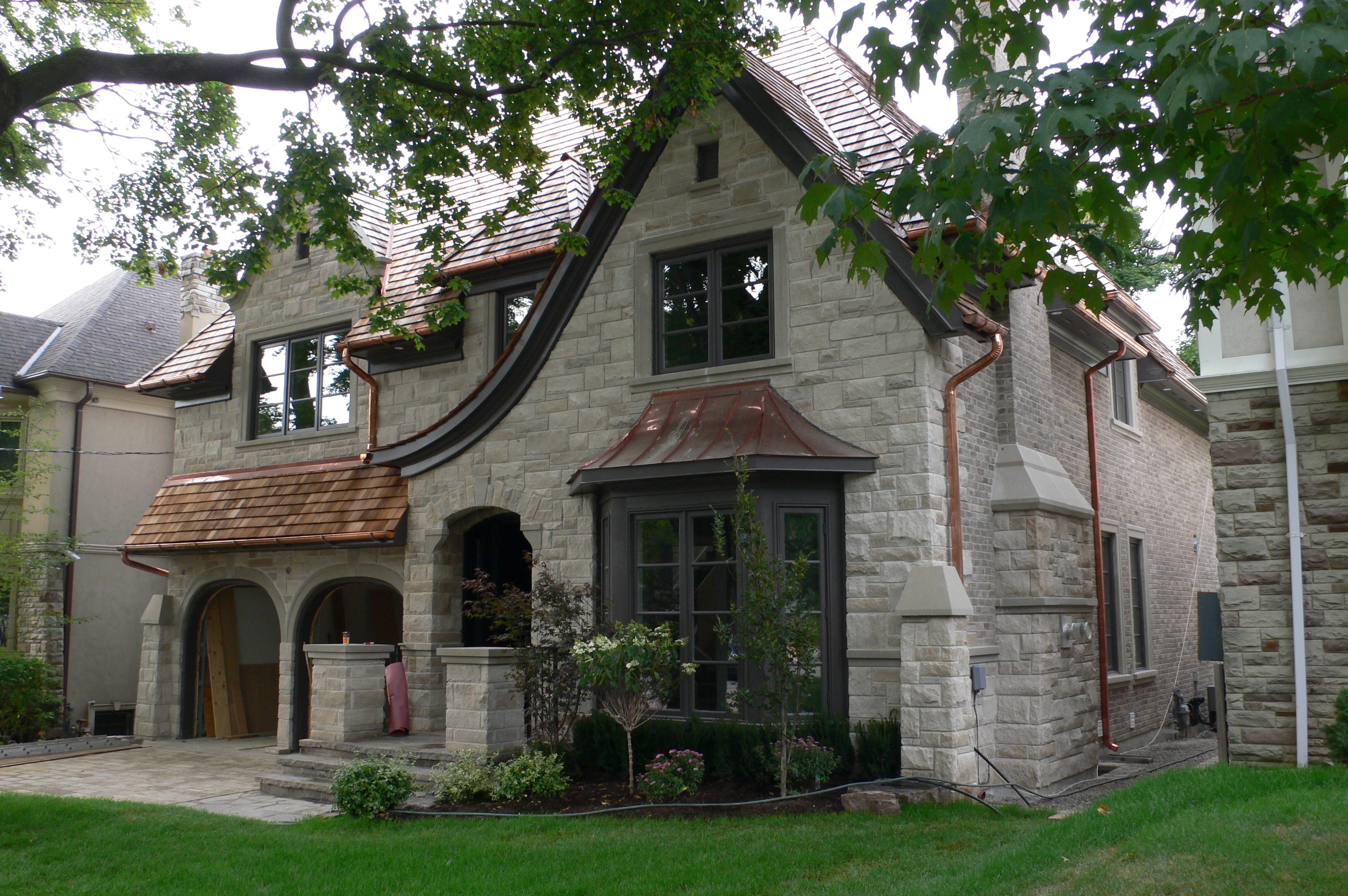 Traditional stone home with copper gutters